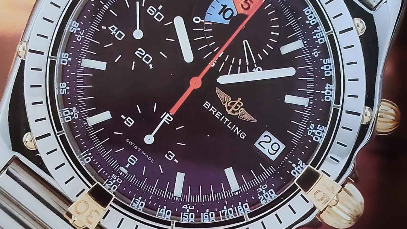 Breitling Chronomat chronograph with black dial and rider tabs on a steel bracelet