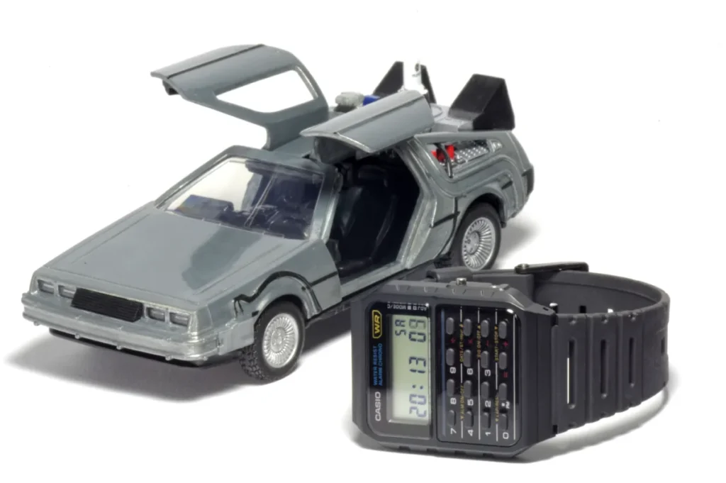 Casio CA-53W calculator watch next to a DeLorean model car referencing Back to the Future