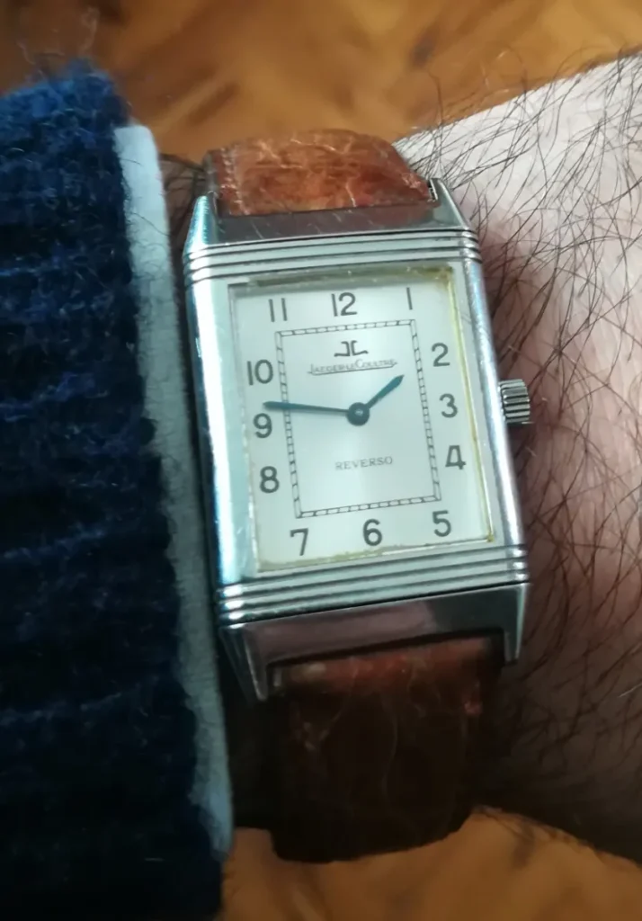 Steel Jaeger-LeCoultre Reverso with silvered dial on a brown leather strap, worn on the wrist
