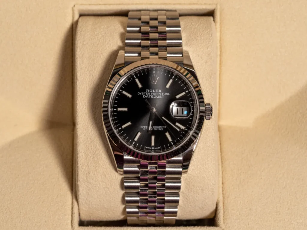 Rolex Datejust with black dial and fluted bezel on a Jubilee bracelet
