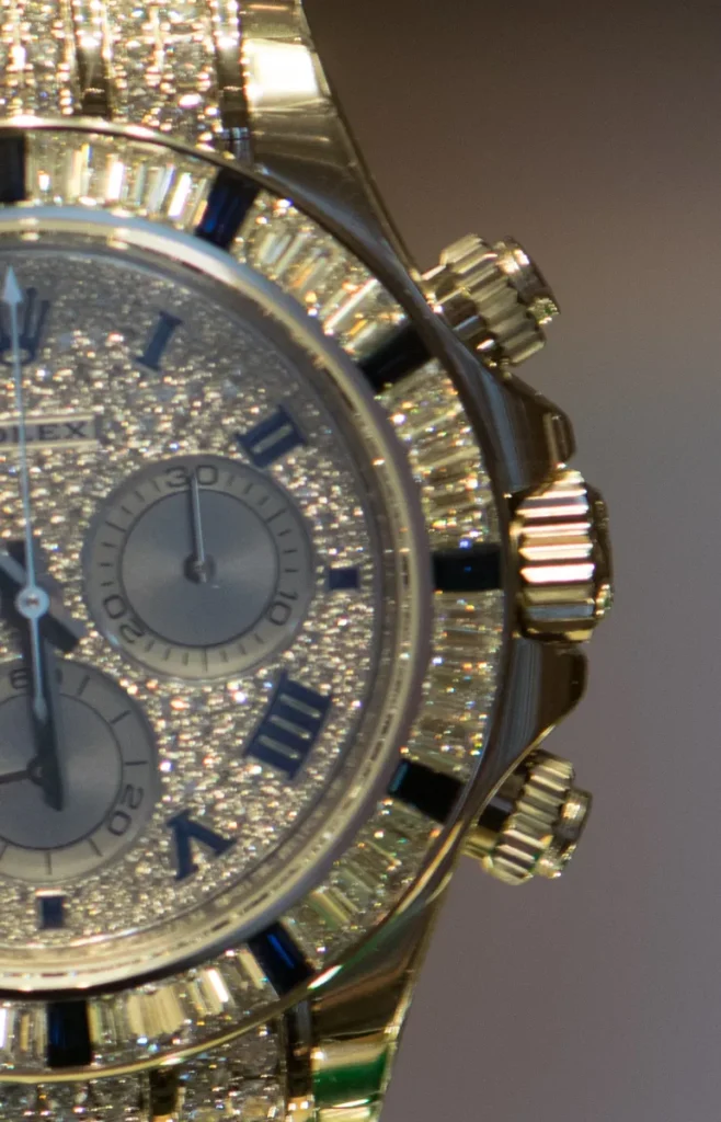 Close-up of the chronograph pushers and crown of a Rolex Daytona