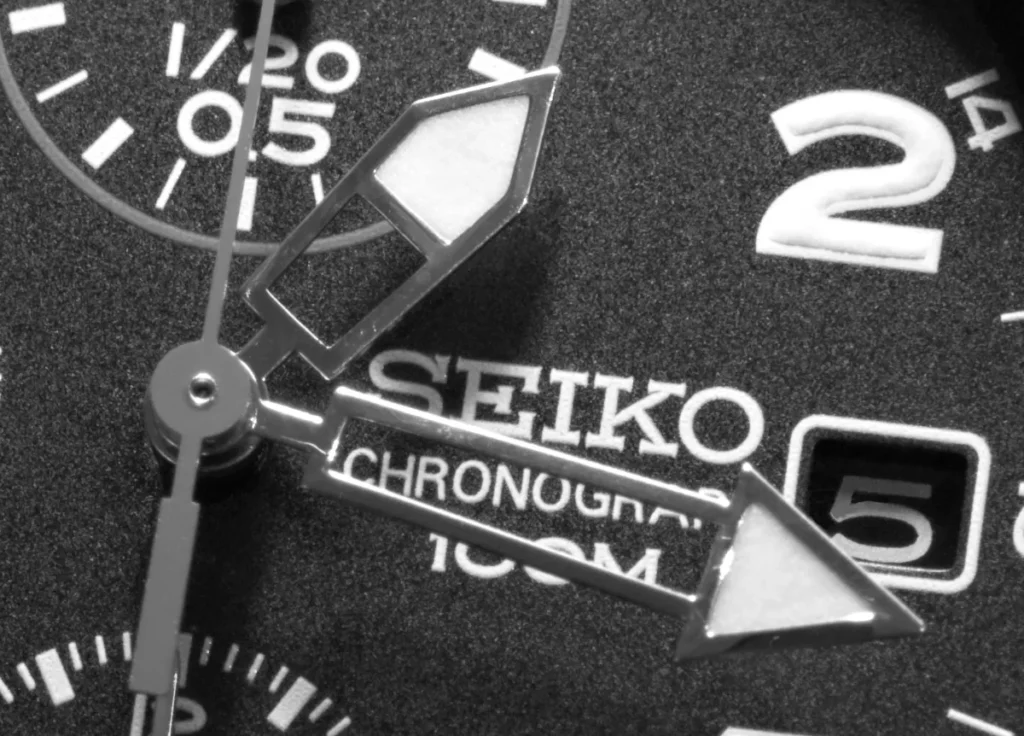 Close-up of the hands and date window on a Seiko chronograph dial