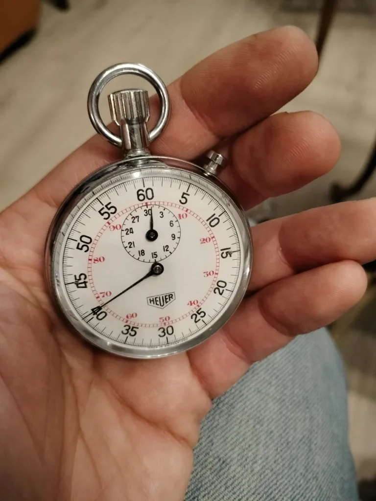 Vintage Heuer mechanical stopwatch from the mid-1970s with white dial
